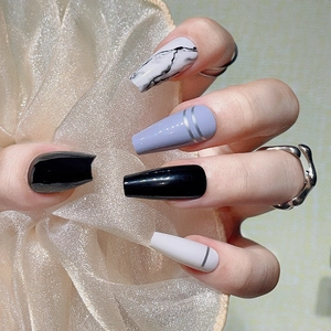 Long coffin-style press-on nails with black, marble, and silver-lined purple designs