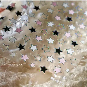 Macro view of M-977 holographic star nail stickers in black, white, and pink