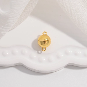 Polished gold S925 sterling silver magnetic clasp for jewelry on white tray