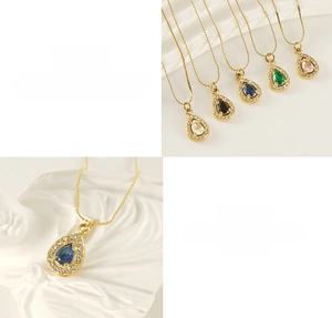 Detail view of pear-cut zircon pendants in multiple colors on a golden chain
