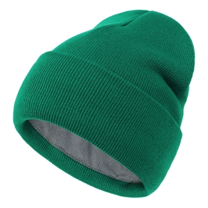 Detailed macro view of the warm gray fleece lining inside the green knitted winter beanie