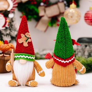 Christmas gnome dolls in red and green with gingerbread patterns and a rolling pin