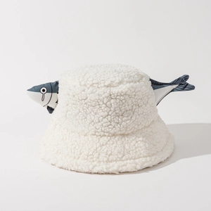 Detail of white sherpa bucket hat featuring a funny blue cartoon fish plush ornament