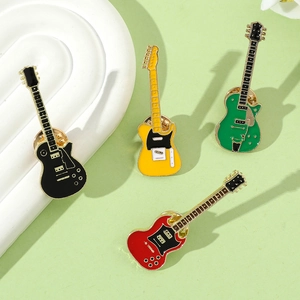 Detailed view of four colorful enamel electric guitar brooches in a stylish arrangement