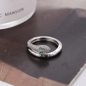 Silver snake ring with green gemstone eyes and white cubic zirconia pave setting