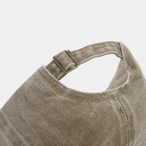 Detail of washed khaki canvas baseball cap with adjustable antique bronze metal buckle