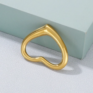 Polished gold hollow heart pendant made of titanium steel on a light blue display stand