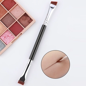 Dual-head angled eyebrow and eyeliner brush with dense red bristles and black handle