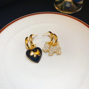 Asymmetric gold puppy earrings with black heart oil drop and sparkling white zircons