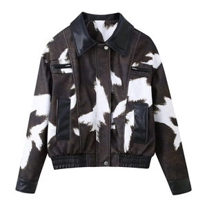 Detail of cow print jacket featuring black leather-look collar and textured animal pattern