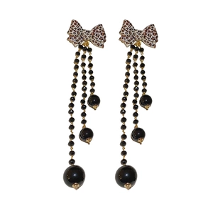Long leopard print bow tassel earrings with black beads and gold-tone metal accents
