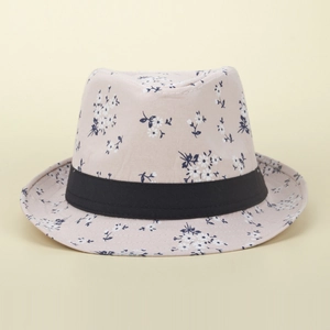 Detail of floral daisy print and black ribbon band on women's pink summer sun hat