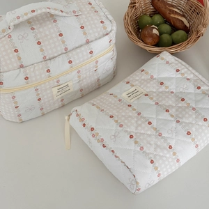 Quilted floral makeup bag set with zipper and handle in a soft lifestyle aesthetic