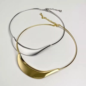 Macro shot of minimalist gold and silver metallic neck collars with adjustable bead chains