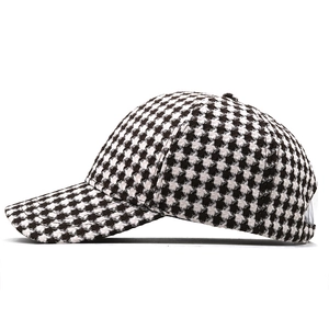 Detailed view of knitted houndstooth pattern and curved brim on a stylish baseball cap
