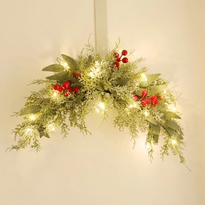 Illuminated Christmas door swag with red berries pine cones and LED pine greenery decor