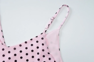 Detail of pink polka dot mesh top featuring adjustable straps and a sexy V-neckline
