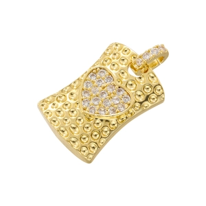 Macro detail of a gold rectangular pendant with a sparkling diamond heart center