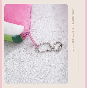 Detailed close-up of watermelon plush coin purse with pink zipper and silver bead chain