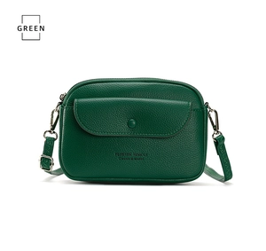 Detail of green lychee grain cross-body bag featuring silver hooks and forever young logo