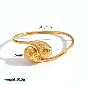 Detail view of gold teardrop cuff bracelet with hammer texture and measurement specs