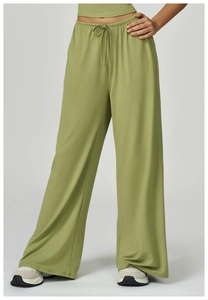 Detail of olive green wide-leg joggers with high elastic drawstring waist and soft texture