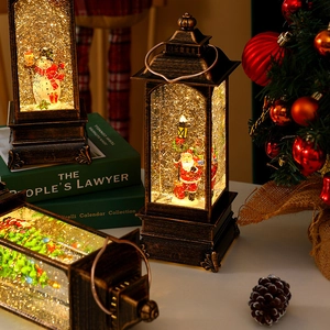 Detail of vintage Christmas lanterns with Santa and snowman figures in warm LED light