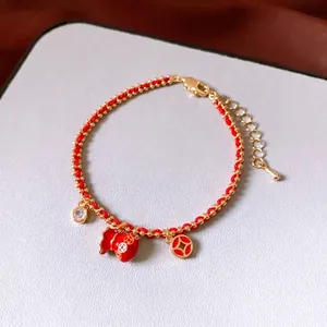Red cord bracelet with 18k gold plated lucky bag and copper coin charms for women