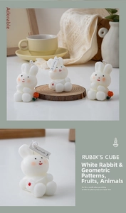 Close-up of white rabbit scented candle with delicate floral details and tag