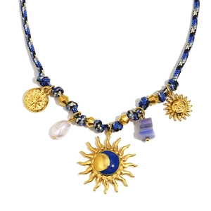 18K gold-plated necklace with sun-moon pendant, pearls, and purple gem on braided rope