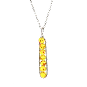Detail of silver chain with wire-wrapped pendant featuring seven yellow beads