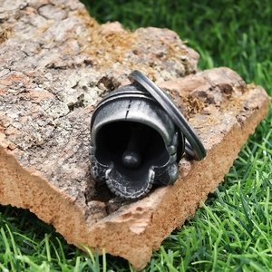 Vintage silver skull guardian bell pendant for motorcycle on natural bark background