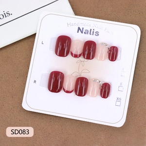 French wine red press-on nails with rhinestone accents and nude pink minimalist tips