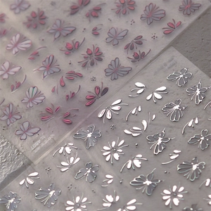 Japanese style gold foil nail stickers featuring pink butterflies and silver floral patterns