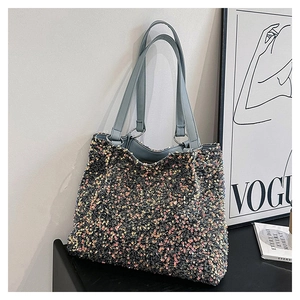 Detail of shimmering multi-color sequins on a stylish tote bag with leather handles