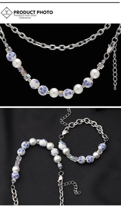 Detail of Chinese style necklace with blue porcelain beads and silver chain