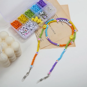 Colorful beaded eyeglass chain set with letter beads and smiley faces in a 10-grid box