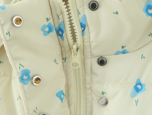Detail of floral hooded jacket showing the zipper and metal snap button closure
