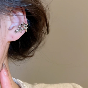 Vue détaillée du clip d'oreille étoile argentée avec zircons porté sur le cartilage