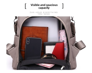 Top view of spacious main compartment in khaki oxford backpack holding laptop and daily items