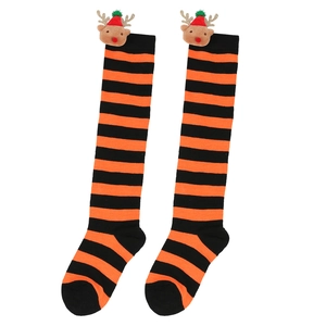 Close-up of kids Christmas knee-high socks with 3D reindeer doll and striped knit pattern