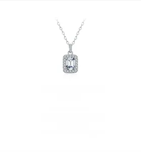 Detailed view of emerald cut moissanite pendant with halo setting on silver chain