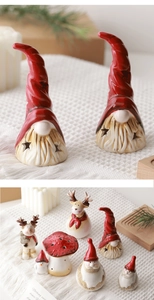 Close-up of vintage ceramic Christmas gnome, reindeer and mushroom with soft lighting