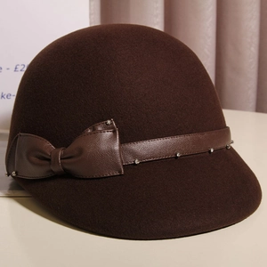 Close-up of brown wool felt equestrian hat with leather bow and rhinestone detail