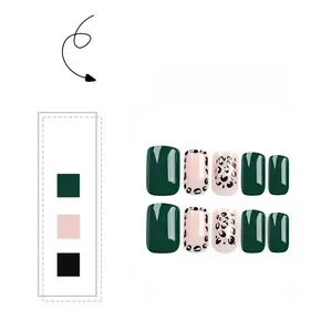 Detail of short square press-on nails featuring green tones and leopard print patterns
