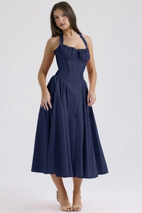 Detailed view of navy blue halter midi dress with a cinched waist and pleated skirt