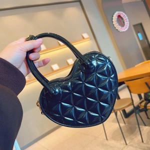 Detail view of heart-shaped PVC jelly bag with quilted pattern and round top handle