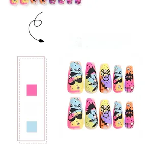 Detail of long coffin press-on nails with graffiti skull heart art and rhinestone accents