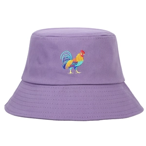 Detailed view of colorful rooster embroidery on a pale purple cotton bucket hat fabric