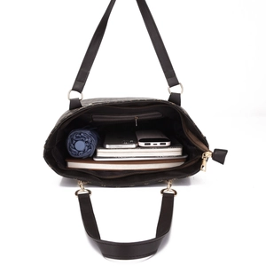 Top view of spacious interior of brown monogram shoulder bag holding everyday essentials